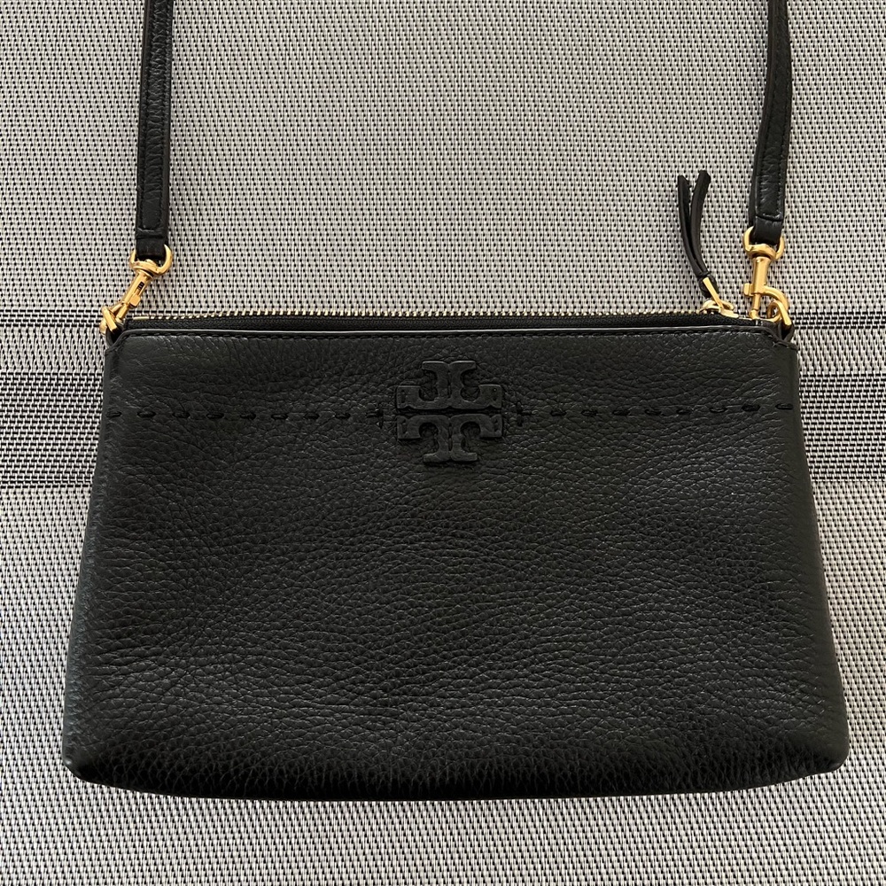 Tory Burch Black Leather shoulder bag with a gold zipper. Compact , yet roomy .